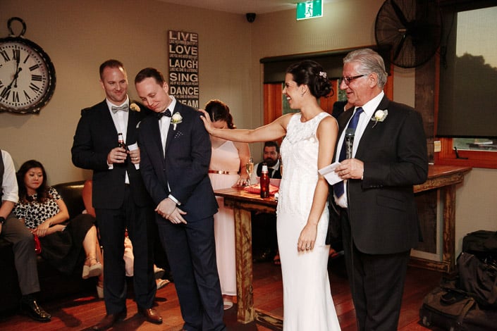 A hand to the cheek for the blushing groom mid-speech