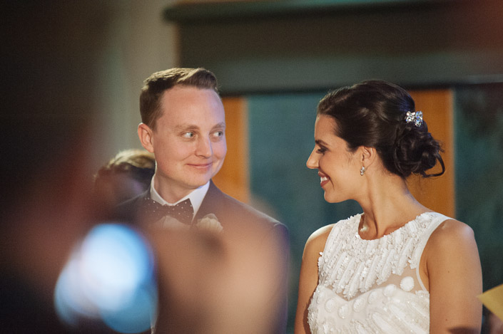 A sideways grin between the groom and bride during the votes of thanks.