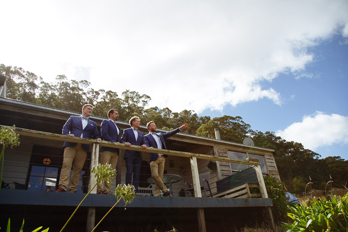 Four men look across the valley from a timber deck at Pennyroyal Otways Retreat