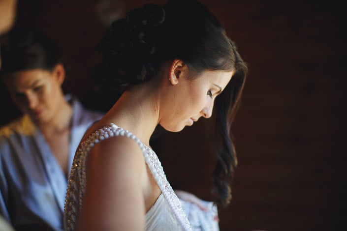 Eyes down in profile, pearls climbing the beaded strap