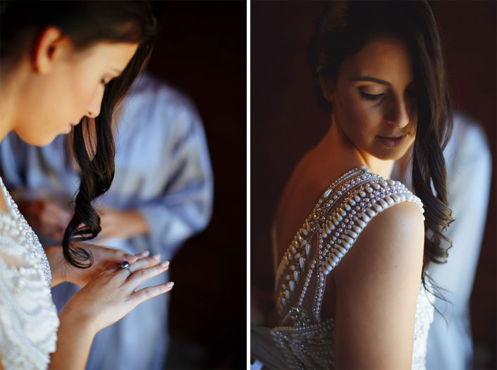 Two frames: the bride turns her sapphire ring, then looks down over the pearl armoured shoulder.