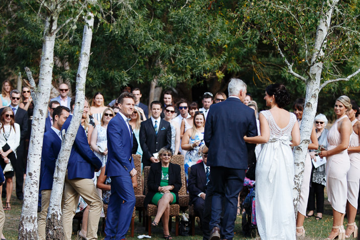 The groom turns towards the bride as she arrives at the ceremony