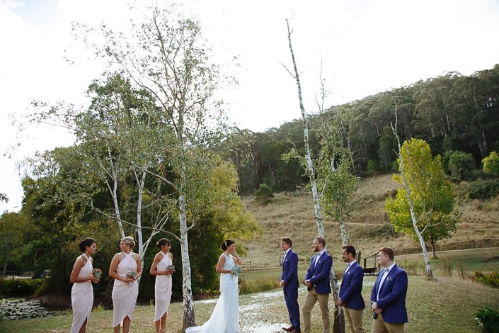 The couple face each other for a lakeside ceremony at Pennyroyal Retreat