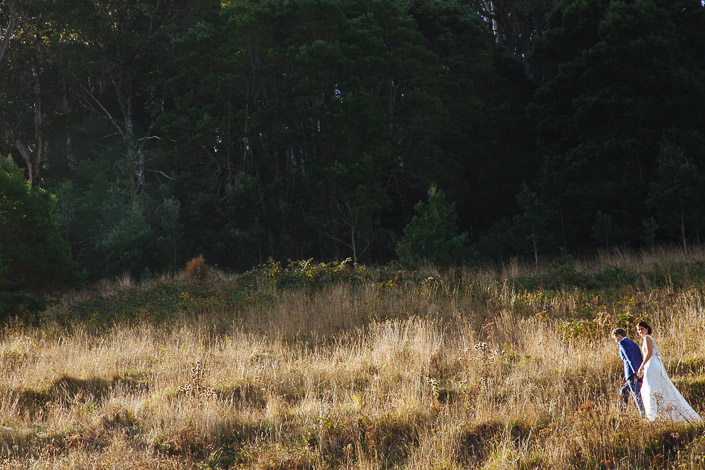 The couple climb a sunlit hillside track at Pennyroyal Otways Retreat in the Otways