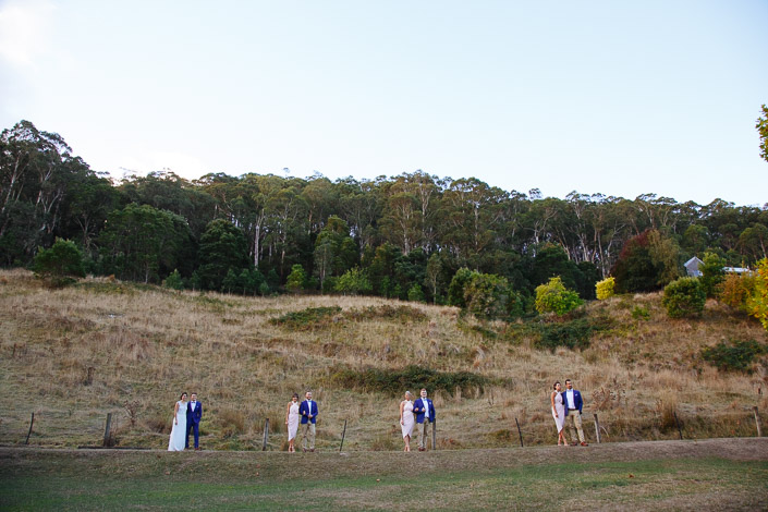 The wedding party spreads along a Pennyroyal Otways Retreat track below the Otways hillside