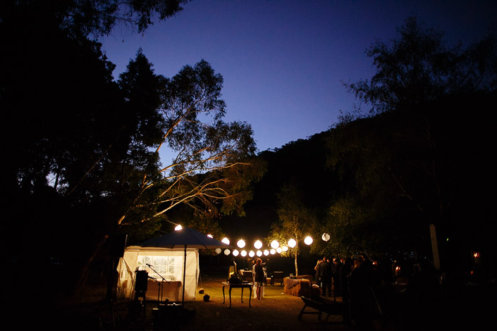 Paper lanterns glow above the Pennyroyal Otways Retreat marquee at blue hour