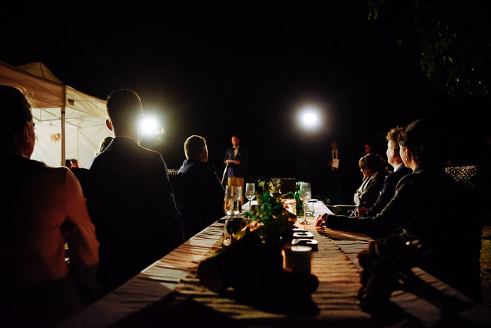 The groom speaks beside a candlelit reception table at Pennyroyal Retreat