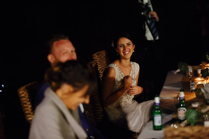 The bride laughs during a toast at the Pennyroyal Retreat reception table