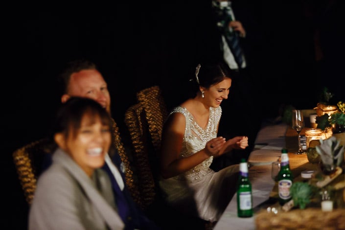 The bride claps beside the candlelit reception table at Pennyroyal Otways Retreat