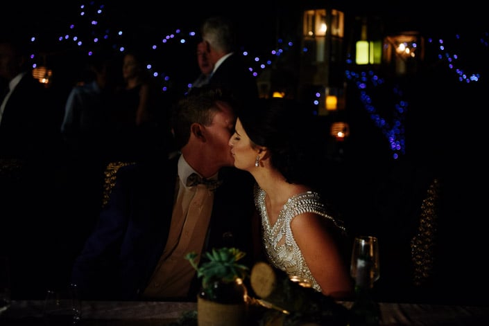 The couple kiss during their wedding reception