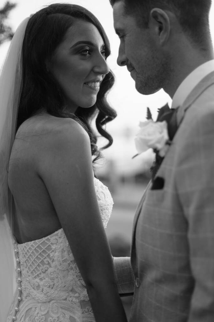 Black-and-white close-up of Georgia smiling towards Michael.