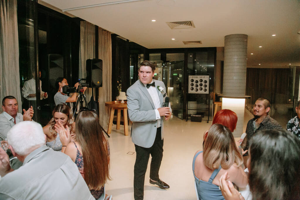 An attendant holds a microphone at waist height as guests applaud at The Prince Deck.