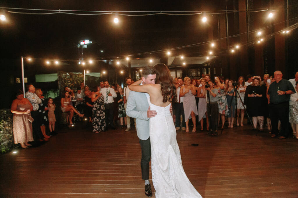 Georgia and Michael share their first dance beneath festoon lights at The Prince Deck in St Kilda.