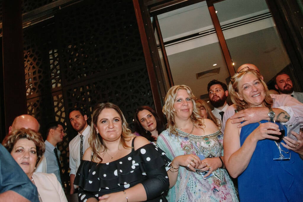 Guests gather beside the geometric screens and open doorway at The Prince Deck.