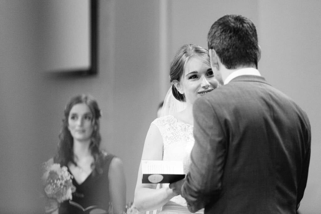 Sue smiles towards Chris during the Syndal Baptist Church ceremony as he holds a small booklet.
