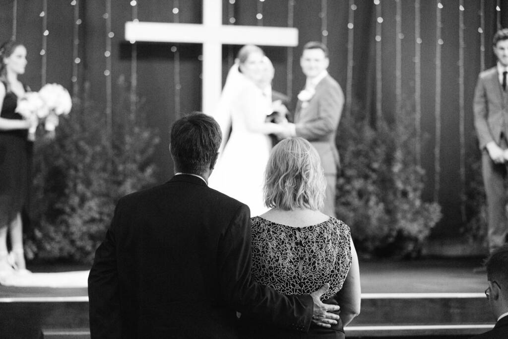 Two guests stand arm in arm in the front row as Sue and Chris face the congregation at Syndal Baptist Church.