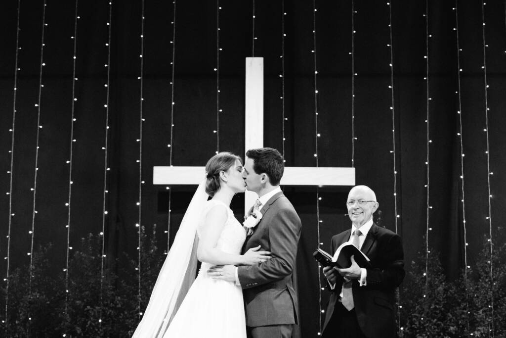 Sue and Chris share their first kiss before the cross at Syndal Baptist Church.