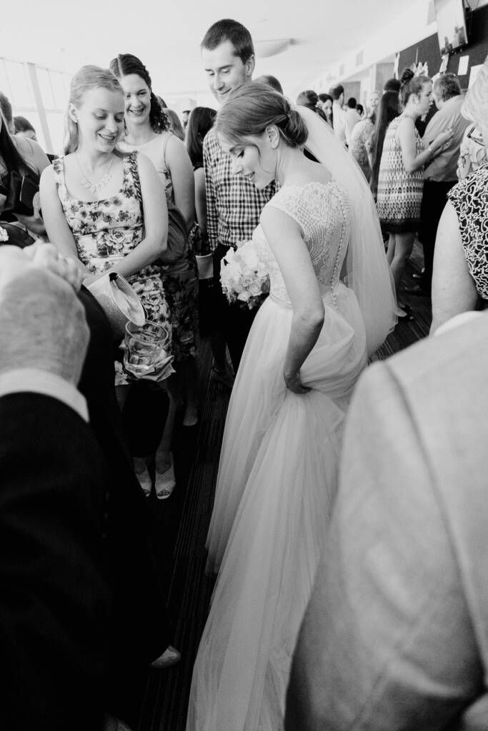 Looking down at her tulle skirt in the foyer, Sue is greeted by a woman in florals.