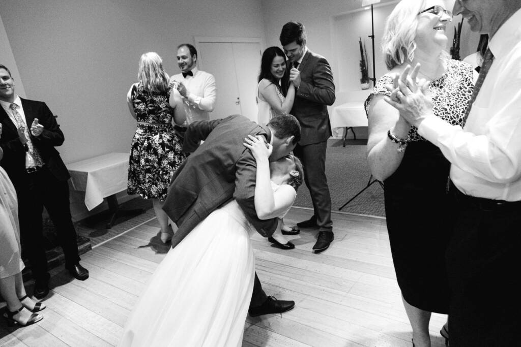 Chris dips Sue in a kiss on the Riversdale dance floor as guests dance nearby.