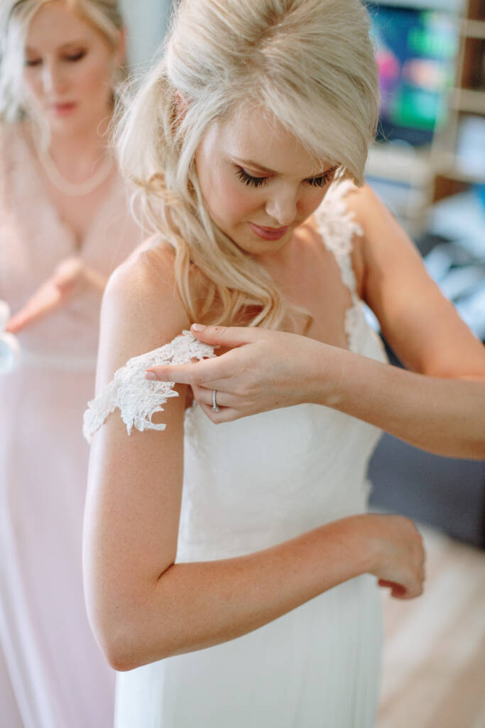 Kate adjusts the lace shoulder detail of her gown.