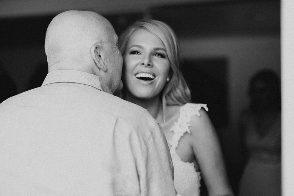 Kate smiles as an older guest greets her with a cheek kiss.