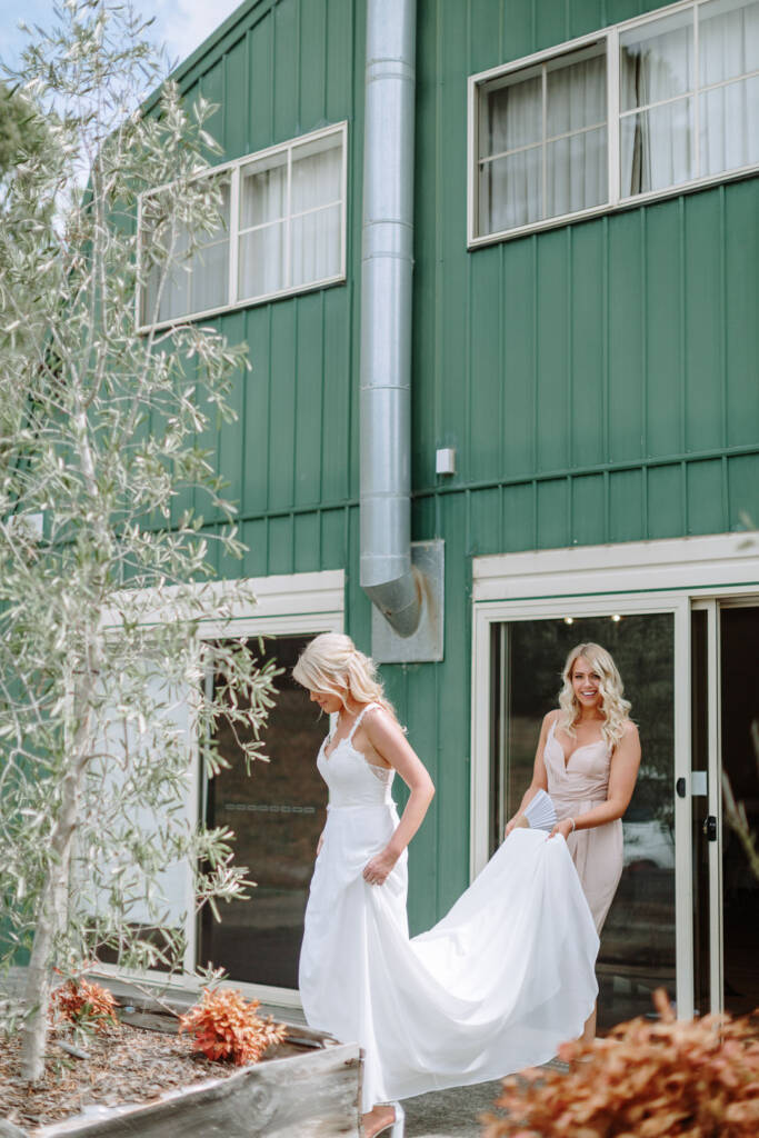 Kate leaves her green-clad Chum Creek Airbnb as an attendant carries her gown's train.