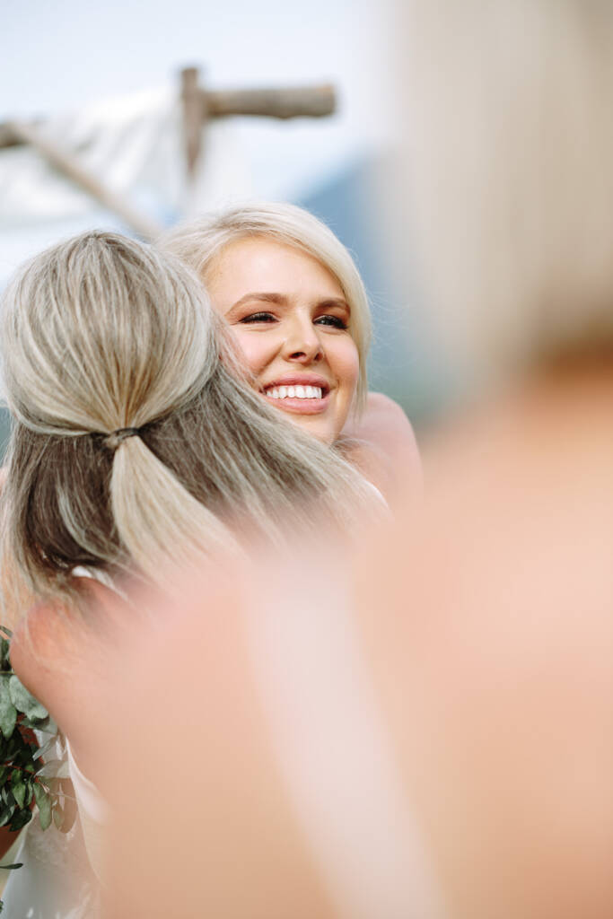 Kate smiles while hugging a guest after the ceremony.