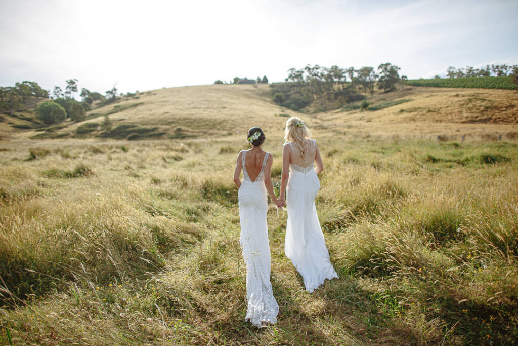 Ashlee and Kate walk through Riverstone Estate's paddocks for their Yarra Valley vineyard wedding portraits.
