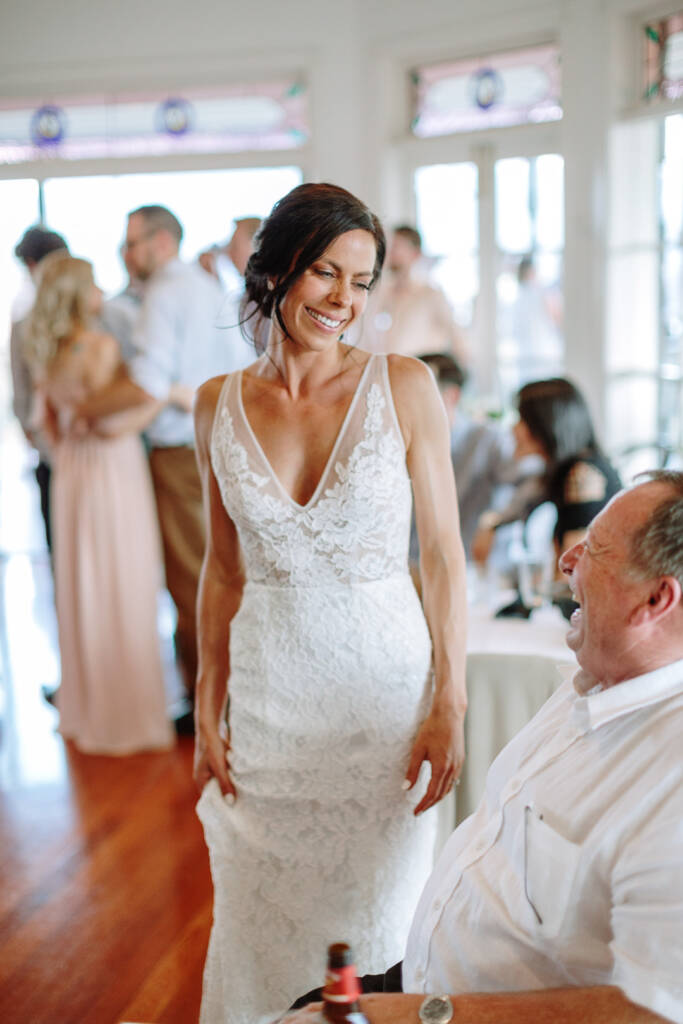 Ashlee smiles at a seated guest in Riverstone's reception room.