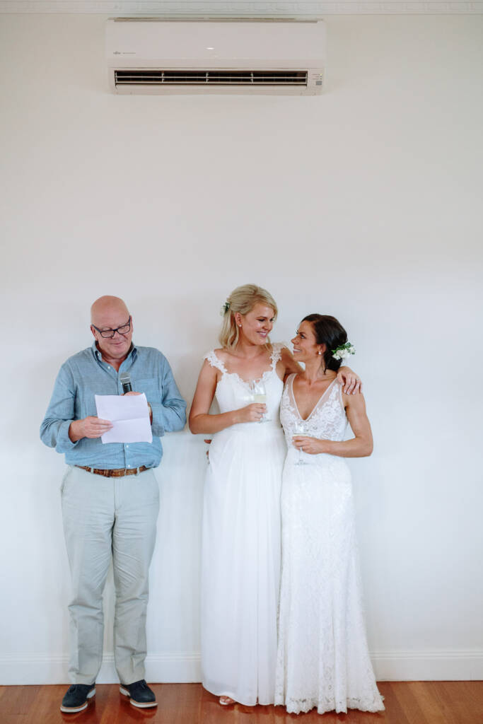 A guest reads a speech beside Ashlee and Kate in the reception room at Riverstone Estate.