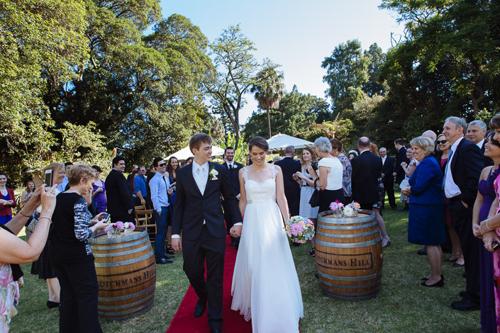 Hand in hand, Frances and Tim walk back down the red carpet as guests applaud.