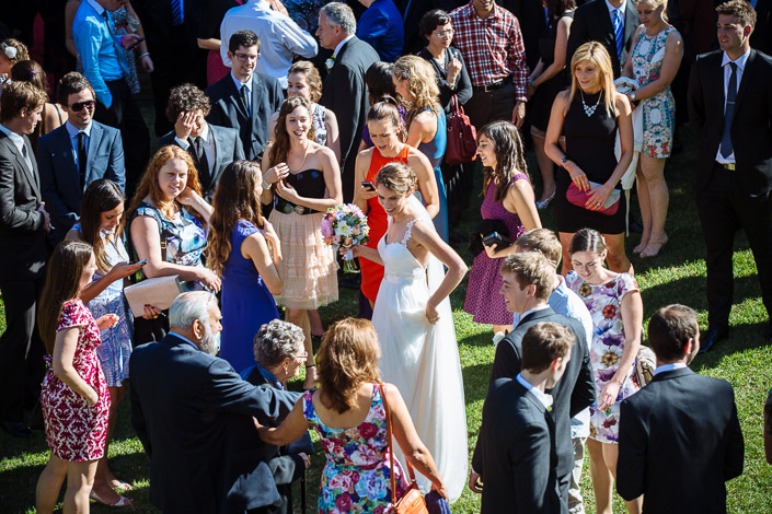 Guests crowd the sunlit lawn to congratulate Frances and Tim after the ceremony.