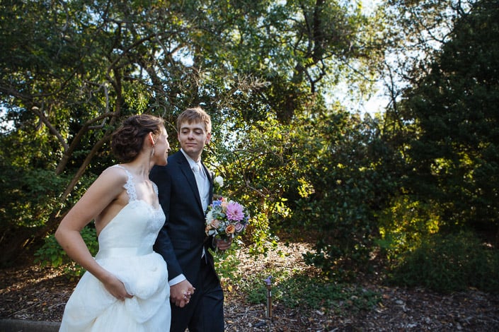 Tim carries the bouquet along a mulched path in golden light at Melbourne's Royal Botanic Gardens.