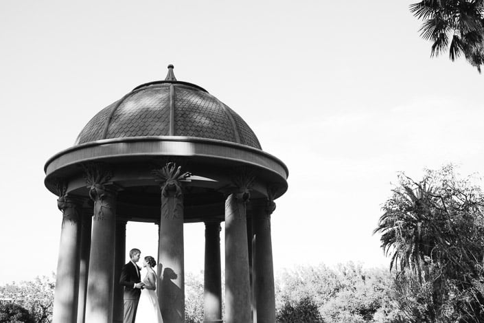 Black and white photo of the couple inside the Temple of the Winds at Royal Botanic Gardens Melbourne.