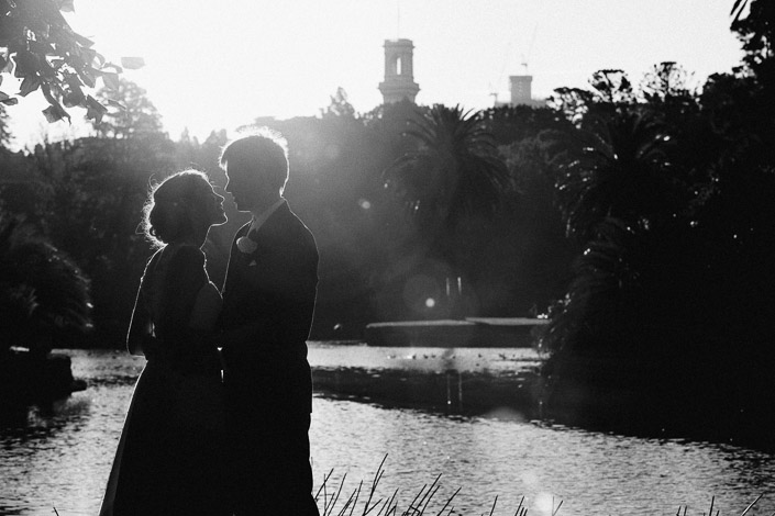 Black and white silhouette of Frances and Tim by the lake at Royal Botanic Gardens Melbourne.