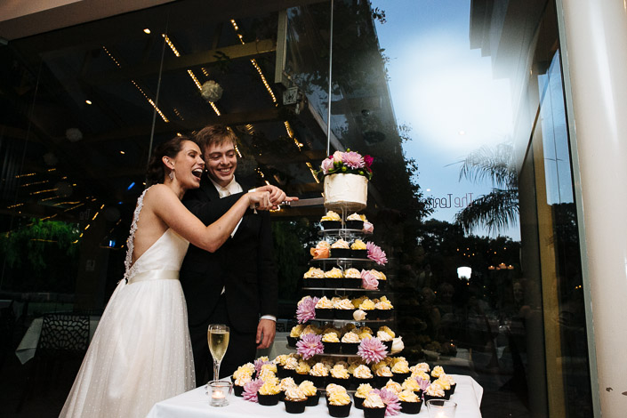 Frances and Tim laugh as they cut a cupcake tower at The Terrace, Royal Botanic Gardens.