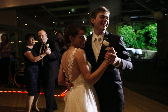 Tim laughs mid-dance holding Frances's hand as guests join them on the floor.