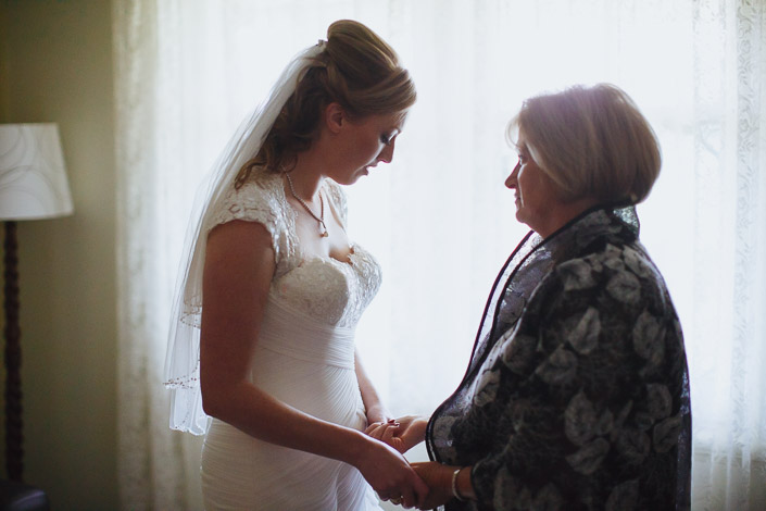 Hands held tight beneath the beaded veil edge