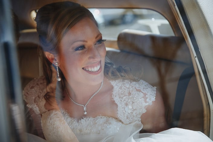 Through the glass, pearls and lace glow against the leather