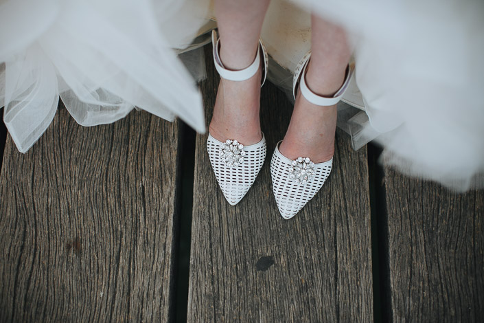 Jewelled toes peek from the tulle on the weathered boards