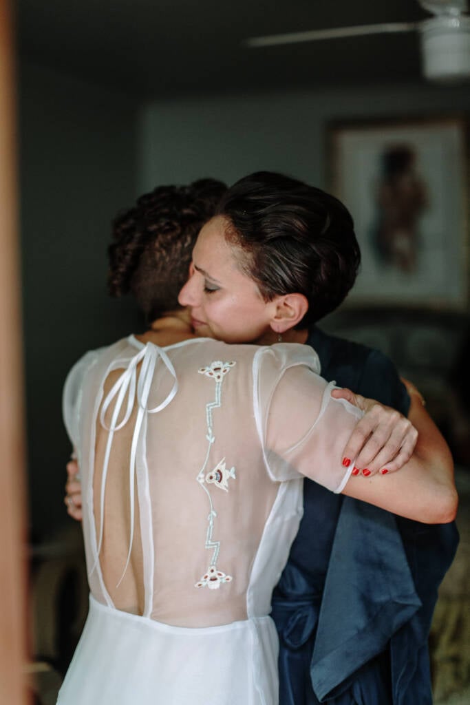 Sarah hugs the person helping her get ready.
