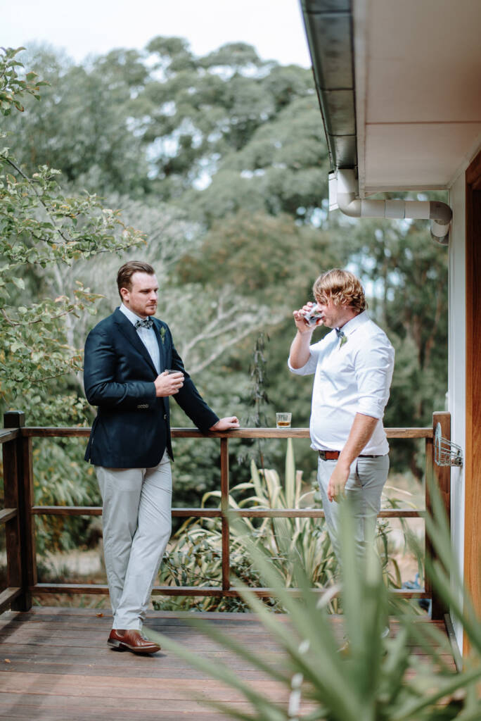 Jye and a companion hold drinks on the verandah at Strathvea.