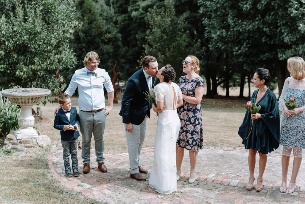 Jye greets Sarah with a kiss as she arrives at the garden ceremony at Strathvea Guesthouse.