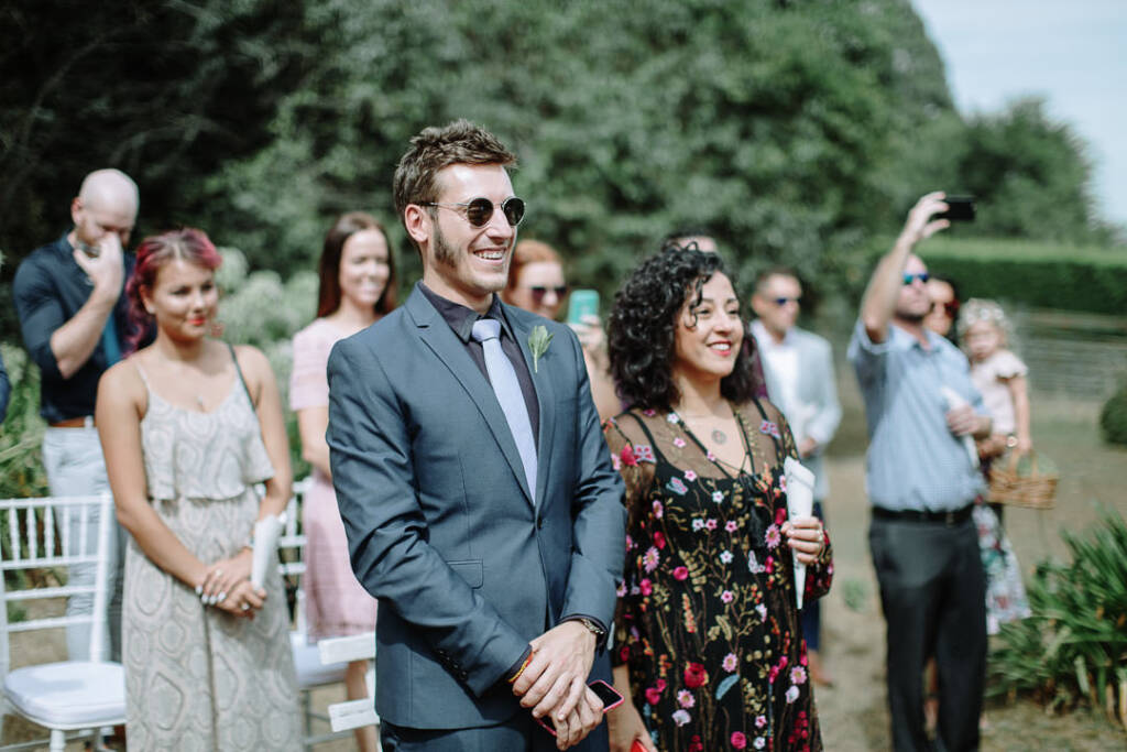 Guests smile beside the garden ceremony chairs at Strathvea Guesthouse.