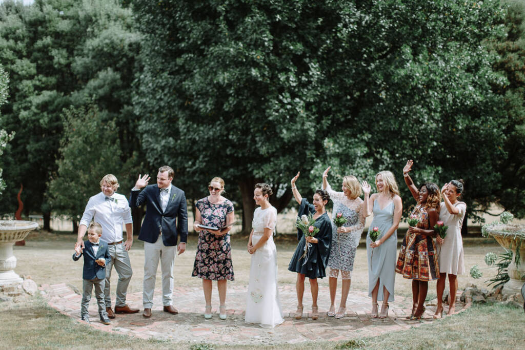 Jye, the attendants and the ring bearer raise their hands during the ceremony at Strathvea.