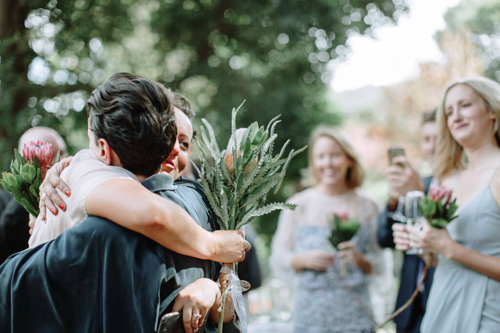 Sarah hugs an attendant after the ceremony.