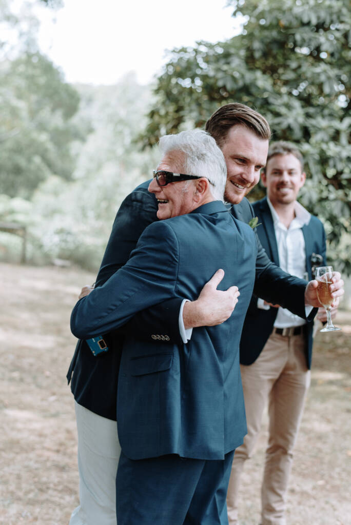 Jye embraces an older guest after the ceremony.
