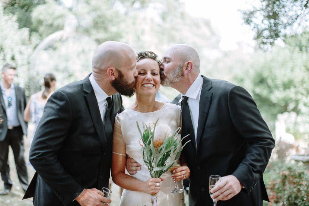 Two guests greet Sarah with cheek kisses.