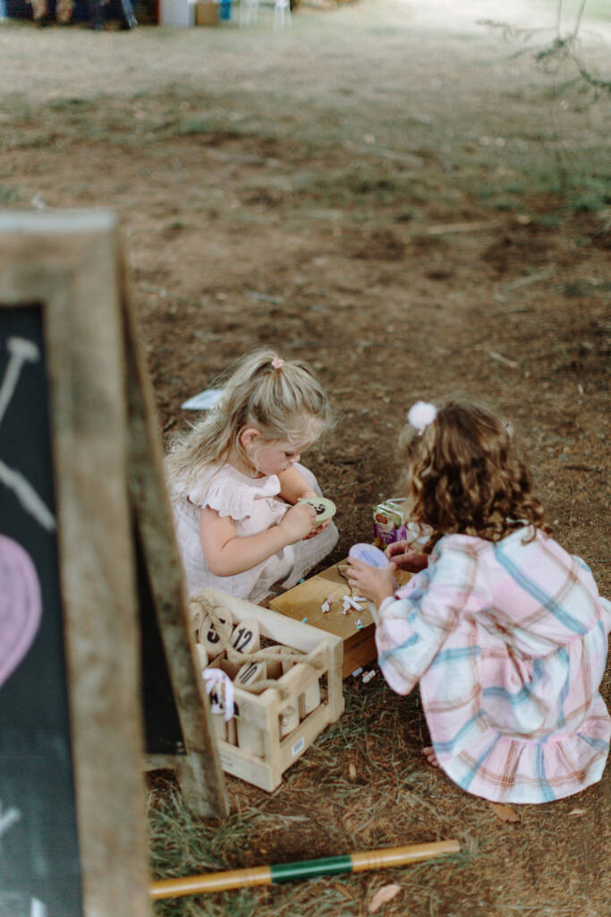 Children gather beside lawn-game equipment in the garden at Strathvea.