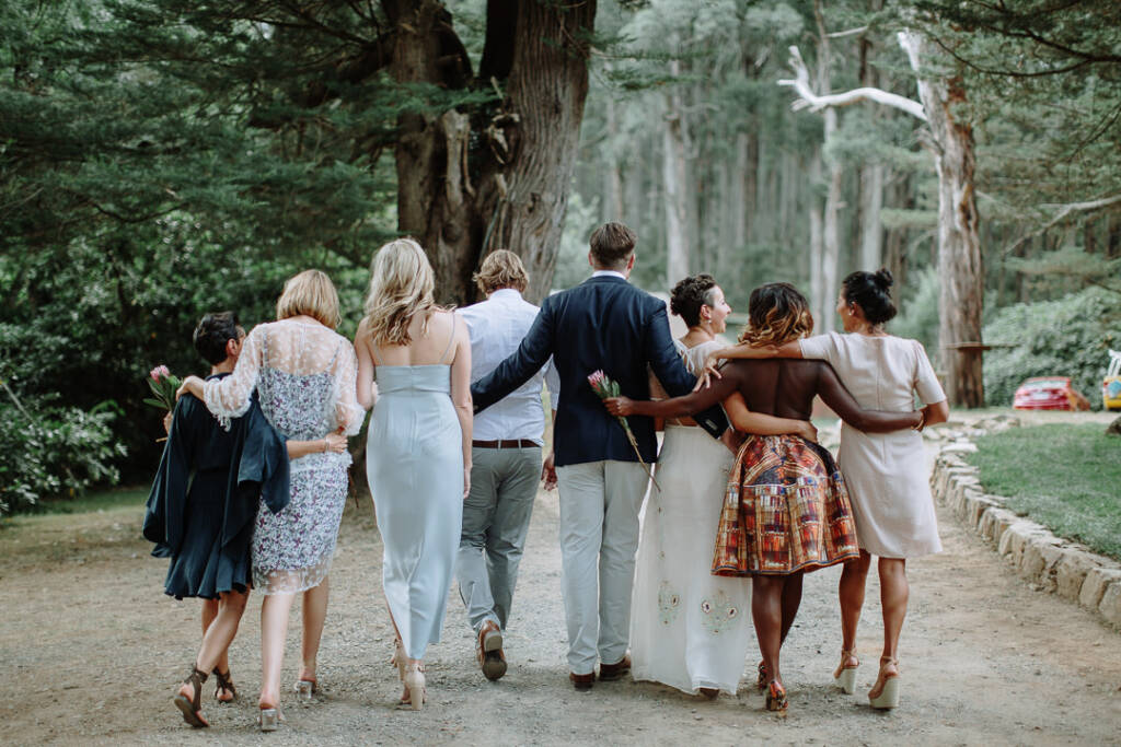 Country wedding portrait of Sarah, Jye and their wedding party on Strathvea Guesthouse's wooded drive.